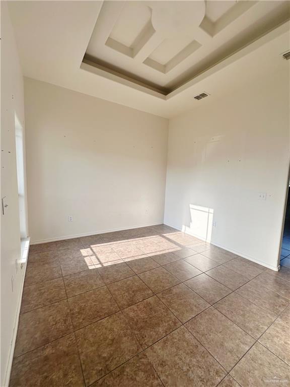 311 Teodora Drive Rio Grande City, TX 78582 - Photo 2 of 15 Empty room with tile patterned flooring and a raised ceiling