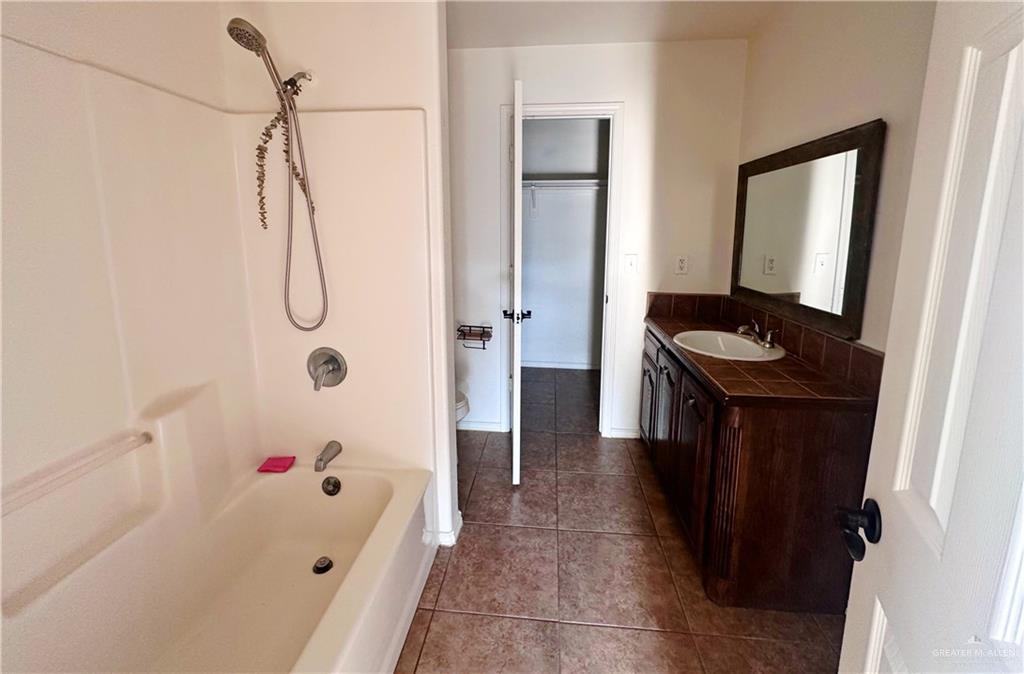 311 Teodora Drive Rio Grande City, TX 78582 - Photo 5 of 15 Bathroom featuring tile patterned flooring, vanity, and tub / shower combination