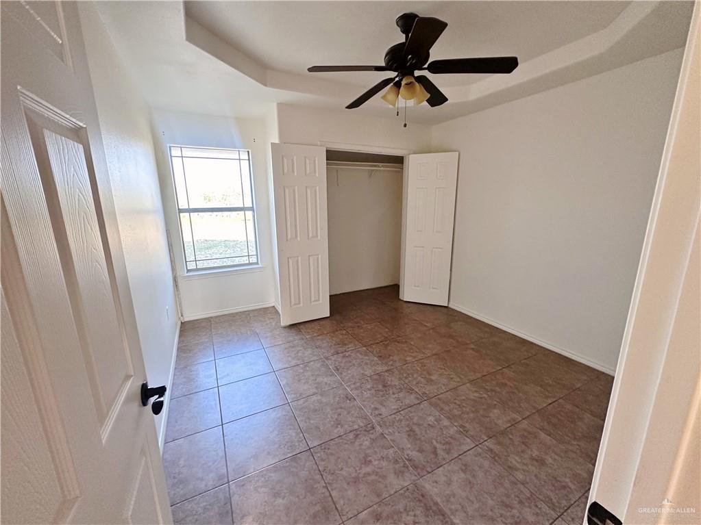 311 Teodora Drive Rio Grande City, TX 78582 - Photo 8 of 15 Unfurnished bedroom with a closet, ceiling fan, and tile patterned flooring