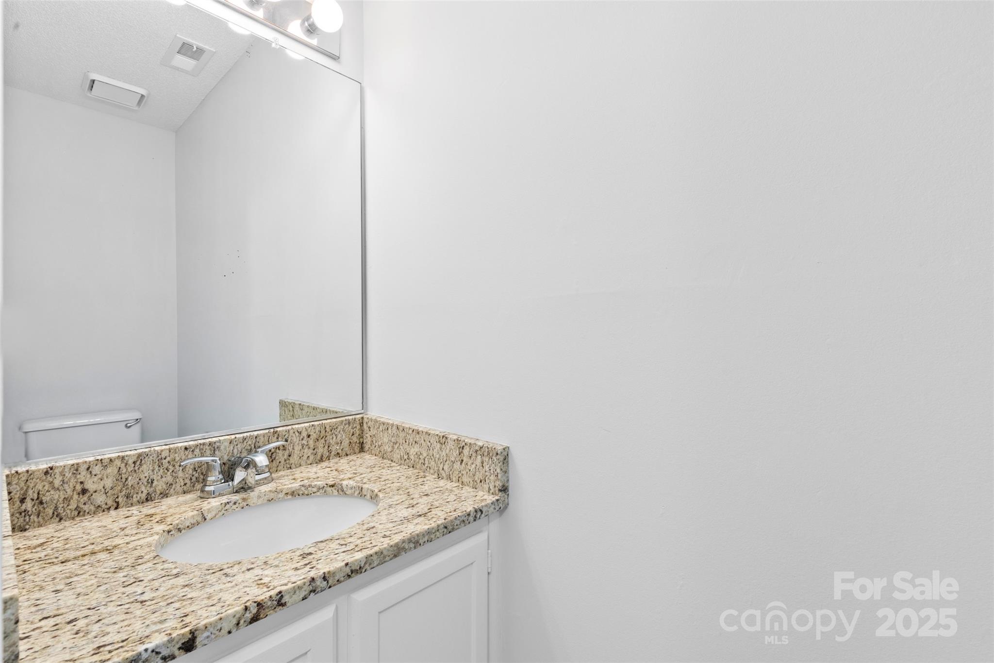 10942 Winterbourne Court Charlotte, NC 28277 - Photo 16 of 27 a bathroom with a granite countertop sink and a mirror
