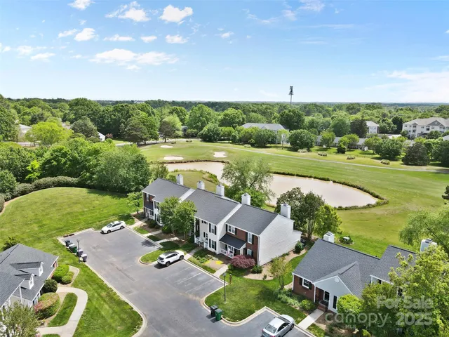 an aerial view of a house with garden space and outdoor seating