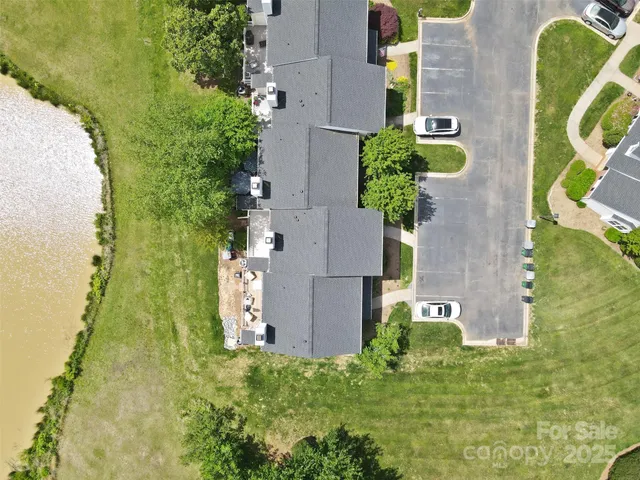 an aerial view of a house with a yard