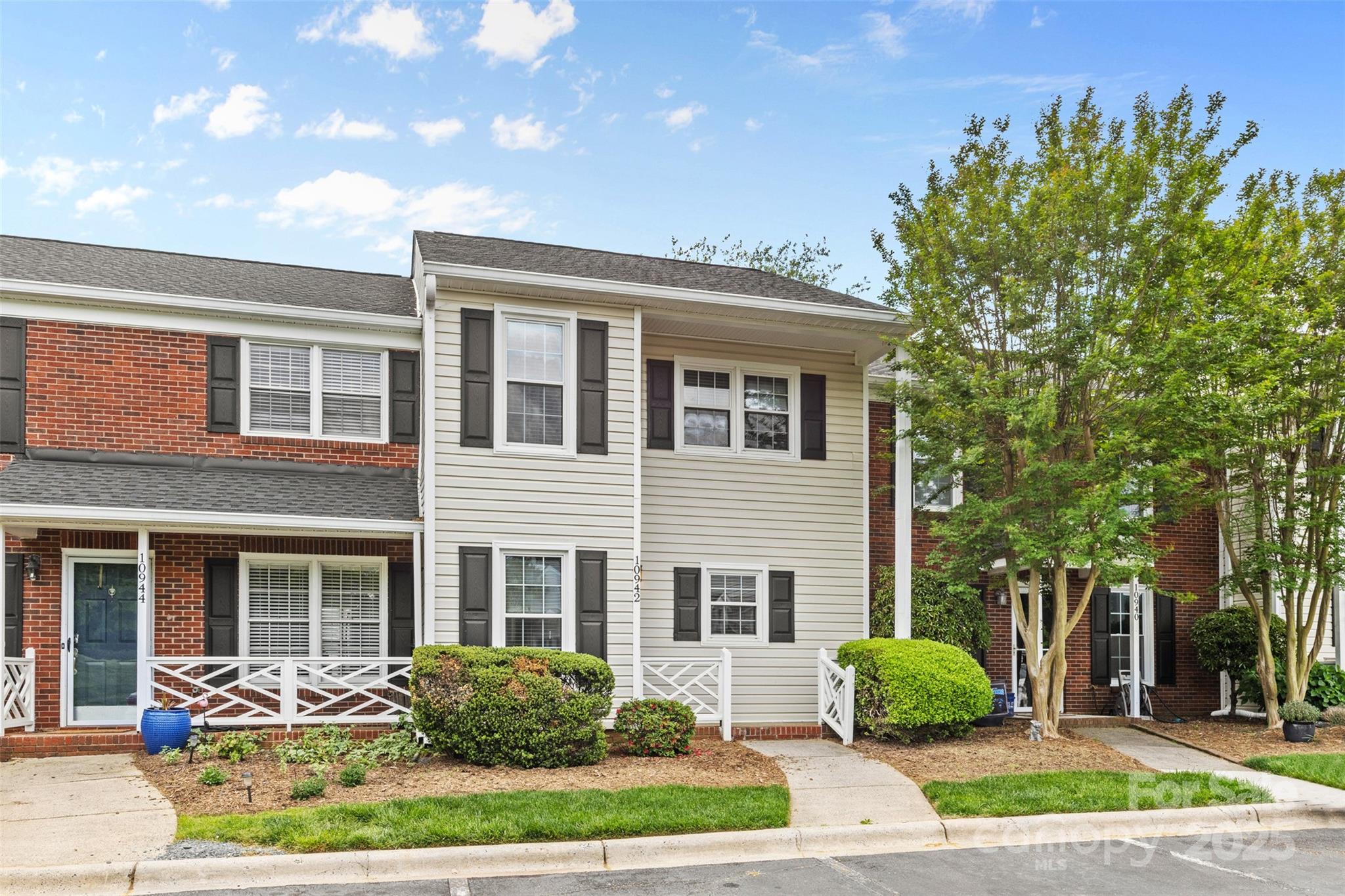 10942 Winterbourne Court Charlotte, NC 28277 - Photo 3 of 27 a front view of a house with garden and plants