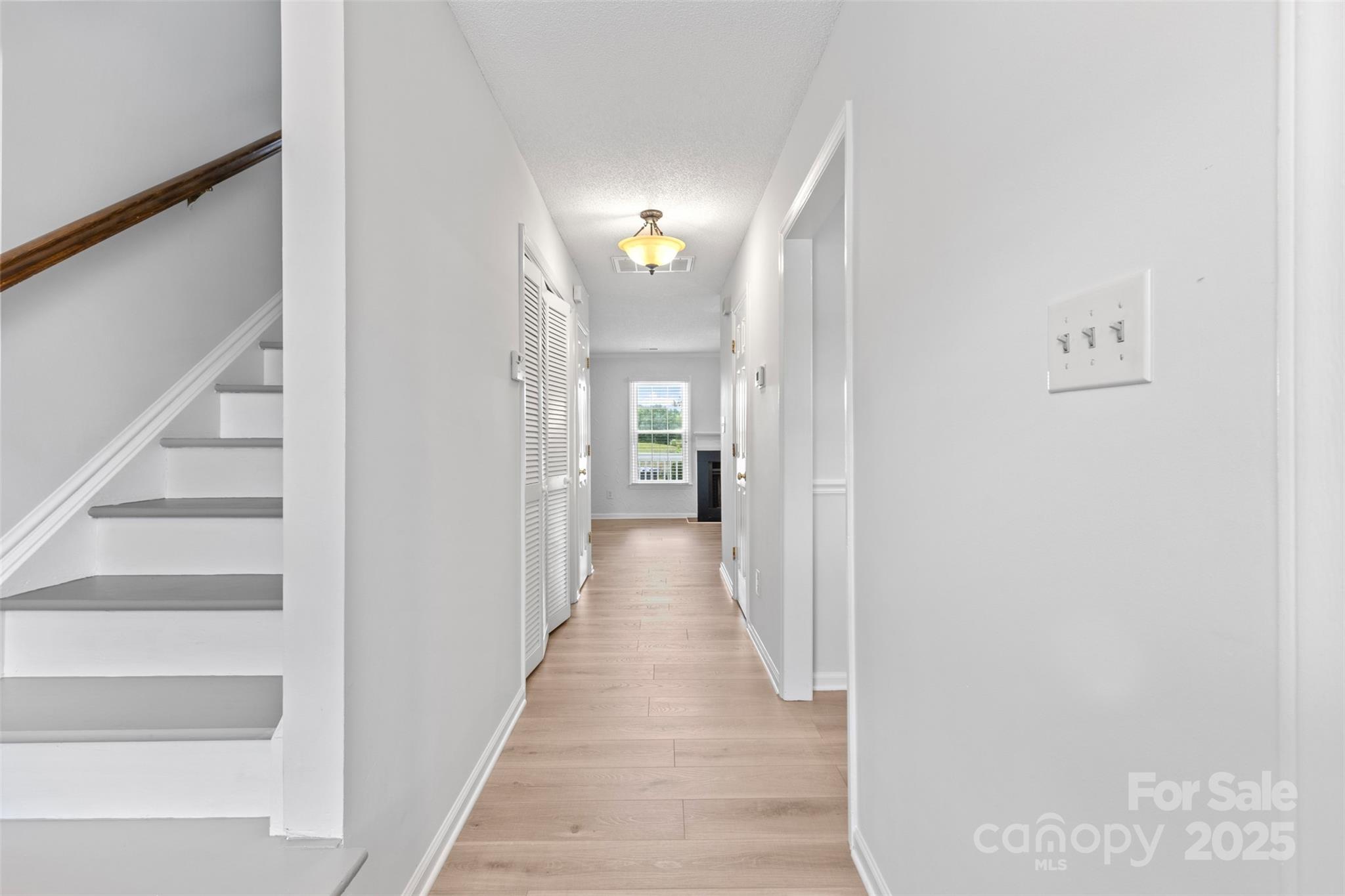 10942 Winterbourne Court Charlotte, NC 28277 - Photo 4 of 27 a view of a hallway with wooden floor and staircase