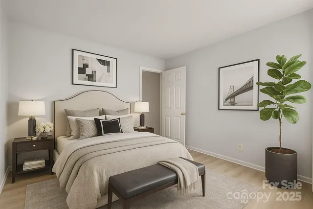 a bedroom with a bed and a potted plant