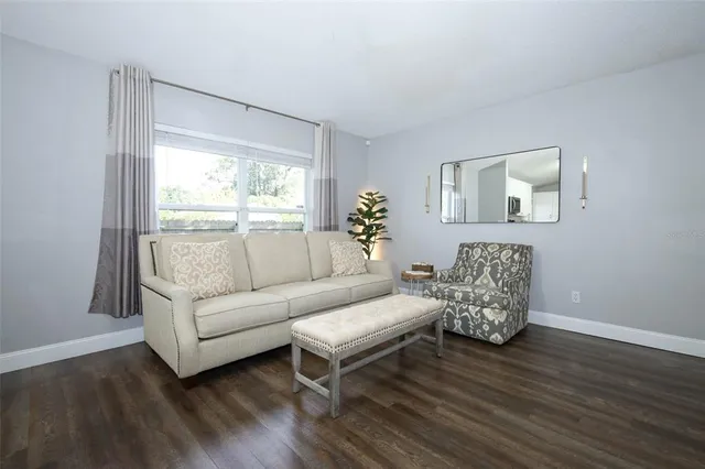 a living room with furniture and a large window