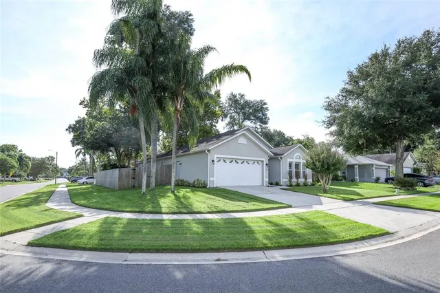 a front view of a house with a yard and trees