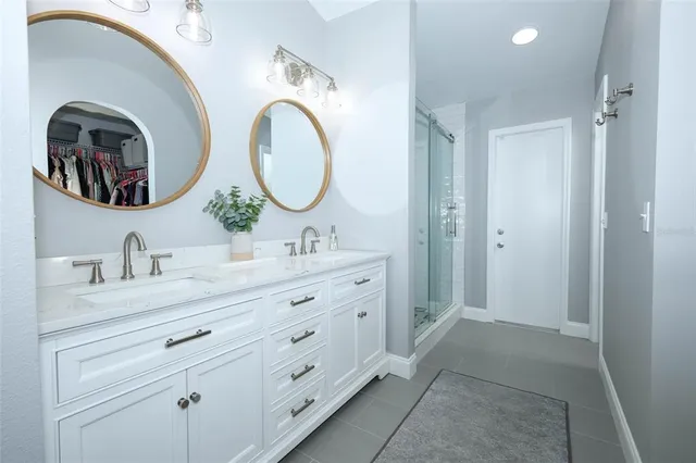 a bathroom with a double vanity sink and a mirror