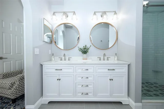 a bathroom with double vanity sink and a mirror