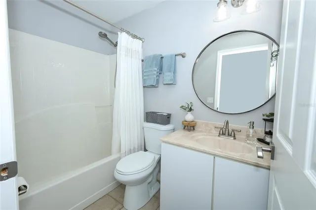 a bathroom with a sink mirror toilet and shower