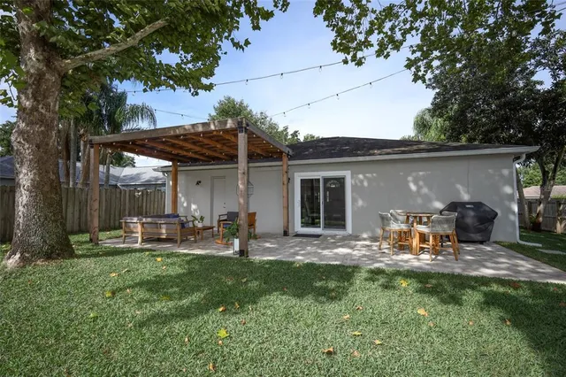 a view of a house with backyard sitting area and garden