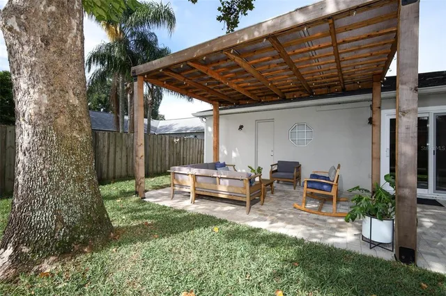 a view of a backyard with sitting area