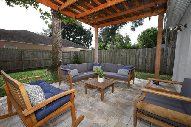 a view of a backyard with a tub and couches with wooden floor