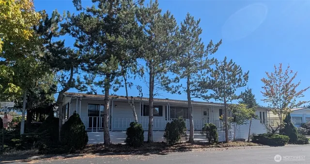 a view of a house with street and trees