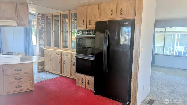 a kitchen with a refrigerator stove and sink