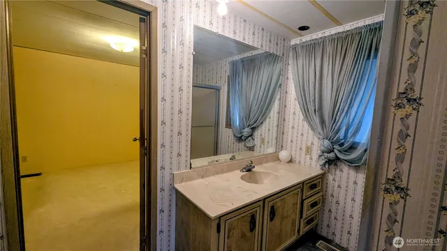 a bathroom with a sink vanity and a mirror