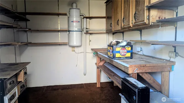 a kitchen with appliances cabinets and a wooden floor