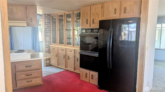 a kitchen with a refrigerator stove and cabinets