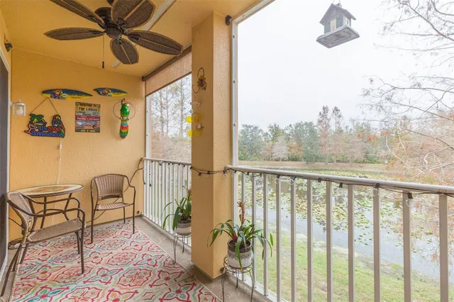 a view of a balcony with furniture and a potted plant