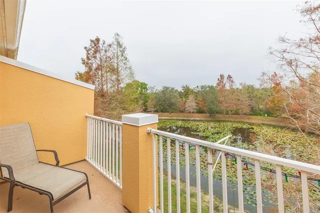 a view of a two chairs and table in the balcony