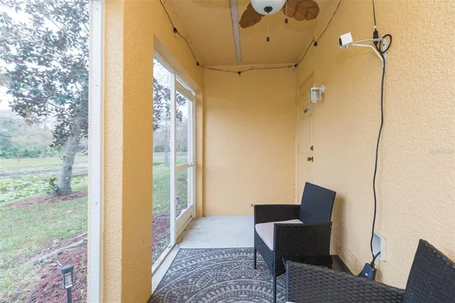 a view of a porch with furniture and a yard