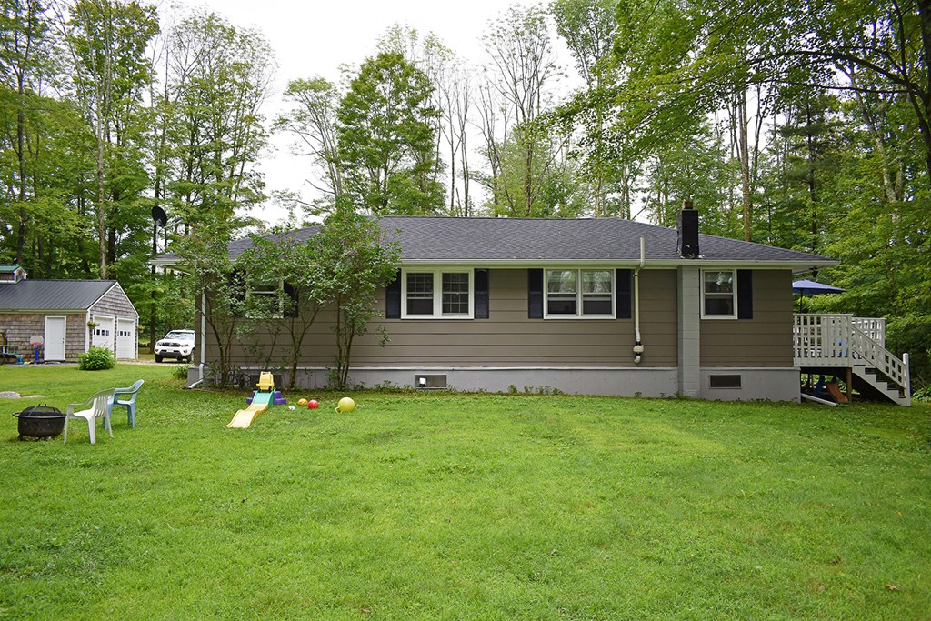 34 Hardwick Road Petersham, MA 01366 - Photo 3 of 24 a backyard of a house with potted plants and large tree