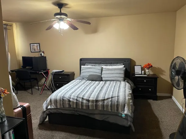 a bedroom with a bed and a chandelier