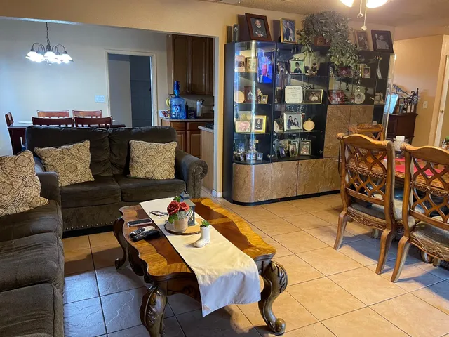 a living room with furniture and a chandelier