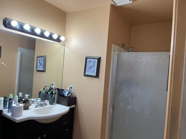 a bedroom with a bed and a mirror