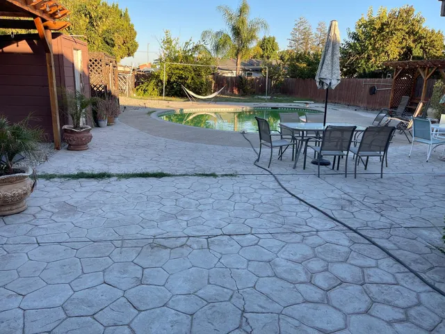a backyard of a house with table and chairs