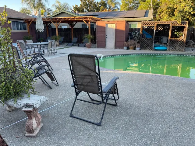 a view of backyard with outdoor seating and trees