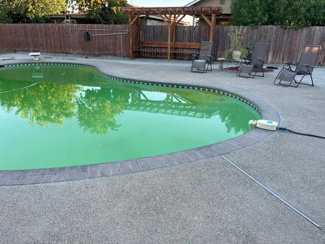 a view of a backyard with swimming pool