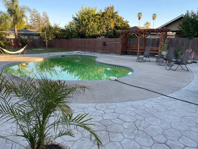 a view of a patio with table and chairs potted plants