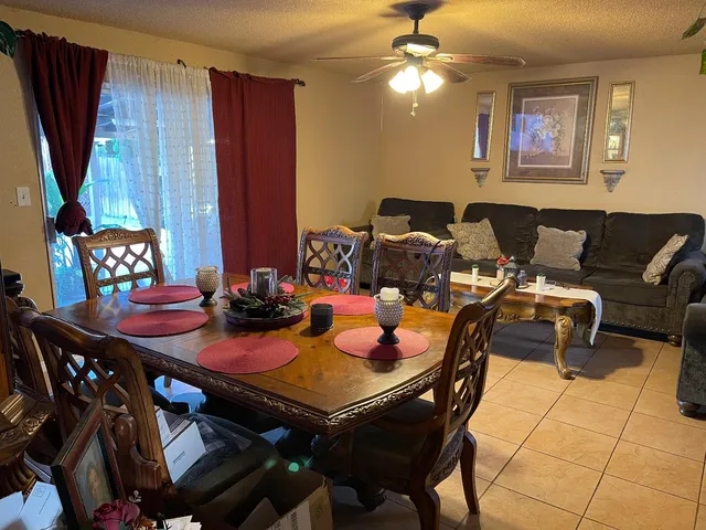 a view of a dining room with furniture and chandelier