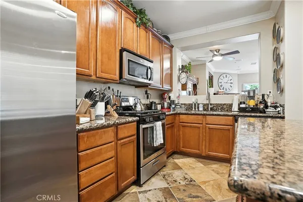 a kitchen with stainless steel appliances granite countertop a sink stove and cabinets
