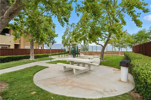 a view of a swimming pool with a yard and plants