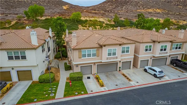 an aerial view of residential houses with yard and swimming pool