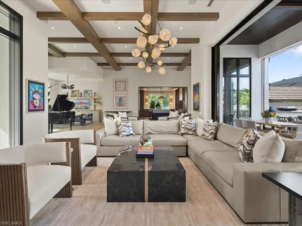 a living room with furniture a chandelier