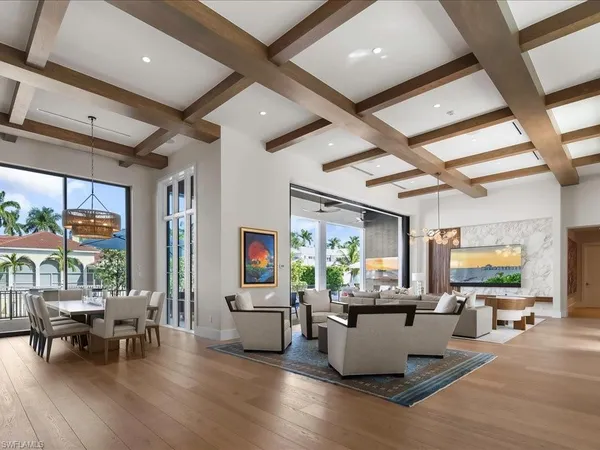 a living room with furniture and floor to ceiling window