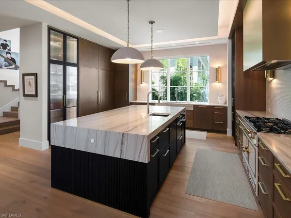 a kitchen with stainless steel appliances granite countertop a stove a refrigerator and a oven