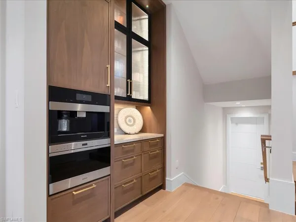 a kitchen with stainless steel appliances a stove and a microwave
