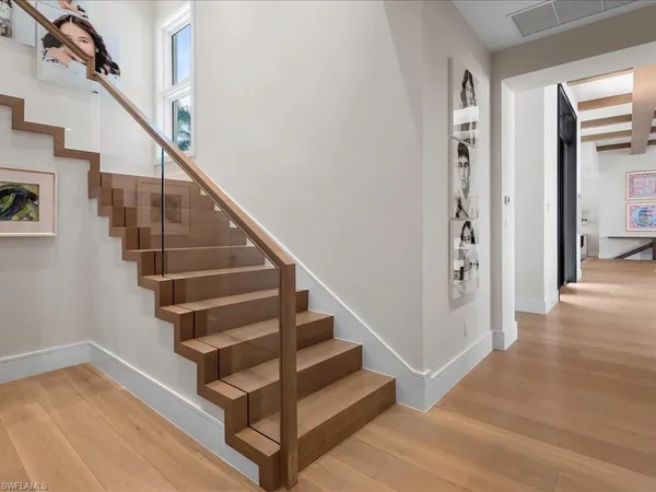 a view of entryway and hall with wooden floor