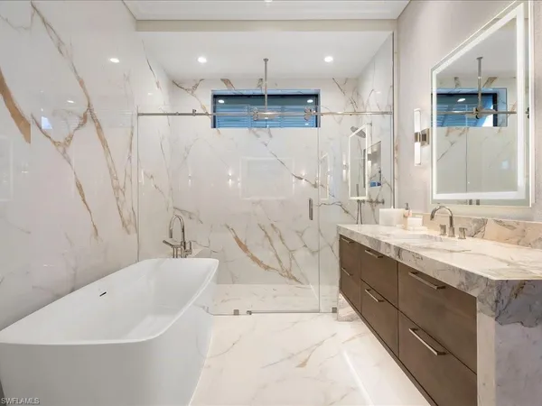 a bathroom with a bathtub a sink a toilet and a shower