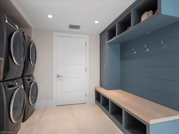 a bathroom with a sink a washer and dryer