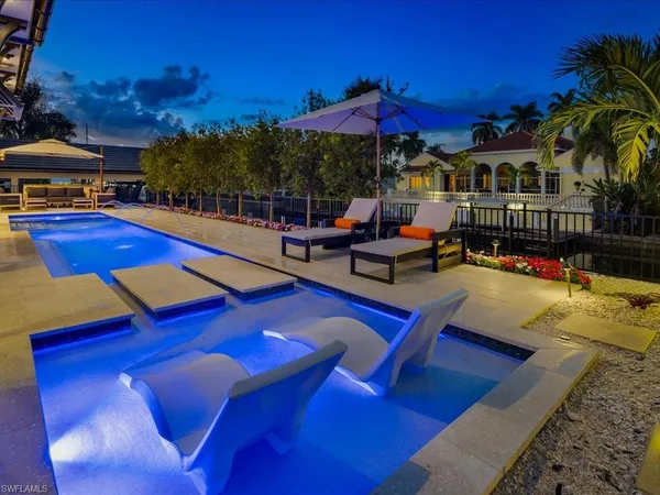 a view of a swimming pool with sitting area
