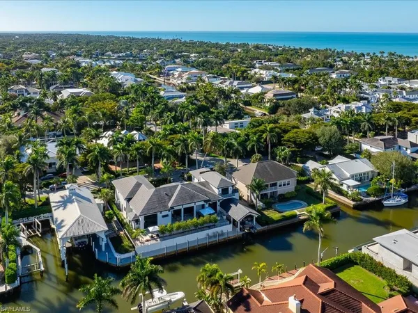 an aerial view of a house with a garden and lake view
