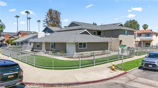 a view of a house with a big yard and sitting area