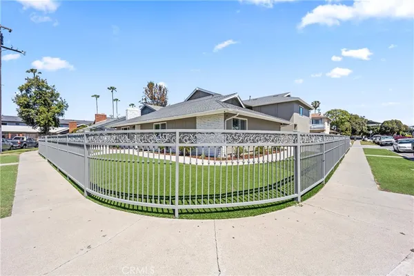 a view of a house with a wooden fence