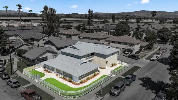 an aerial view of a house with a garden and mountain view