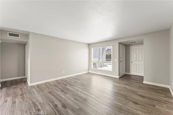 a view of an empty room and wooden floor